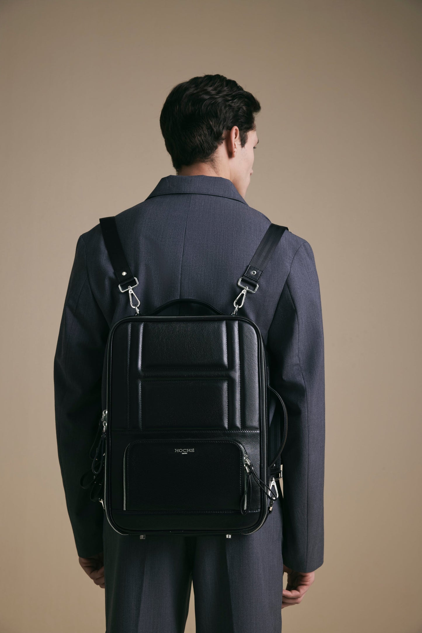 Lifestyle view of UniSwitch black branded genuine leather 3 in 1 convertible backpack for men in India. Stylish and trendy.