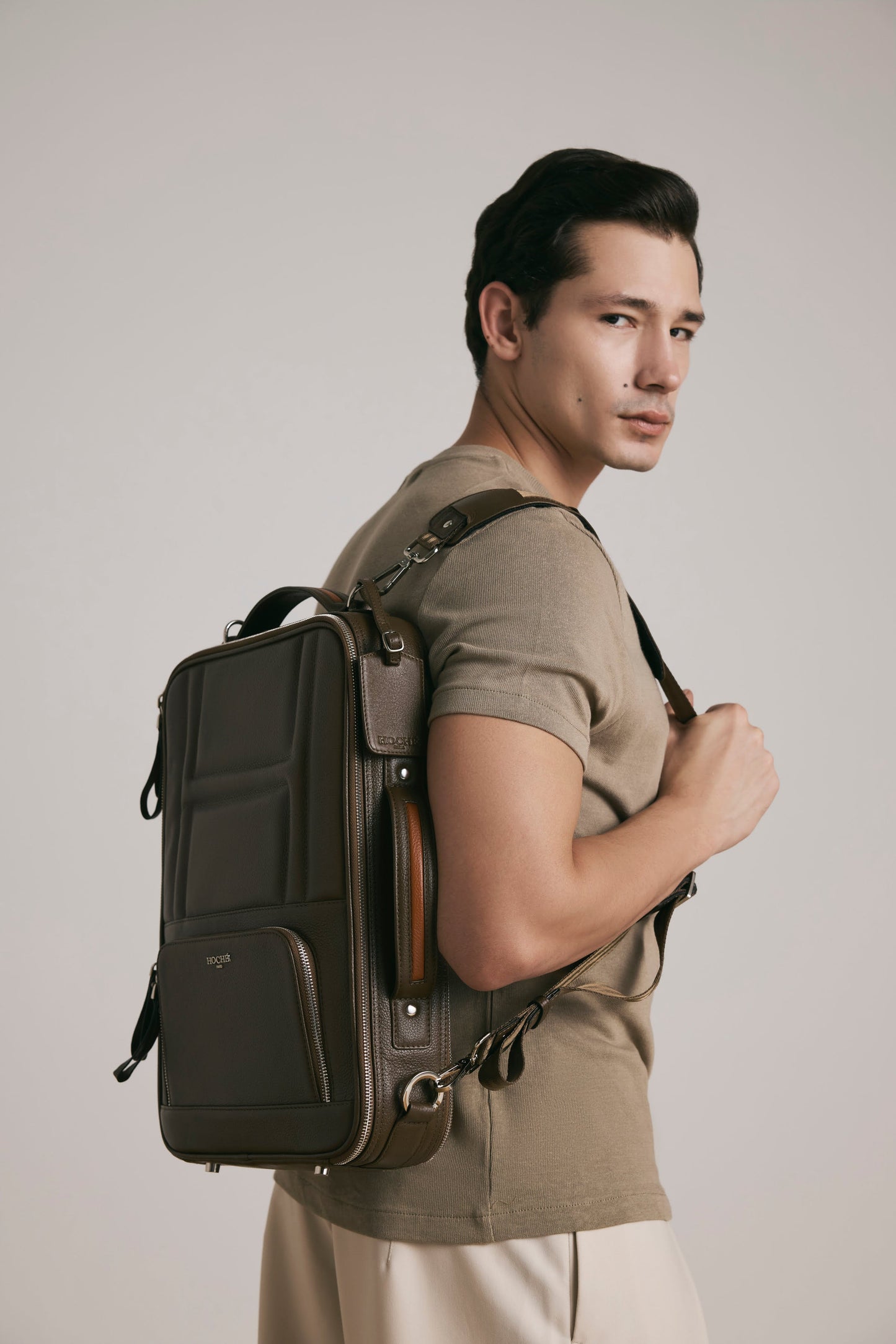 Lifestyle view of UniSwitch dark brown branded genuine leather 3 in 1 convertible backpack for men in India. Stylish and trendy.