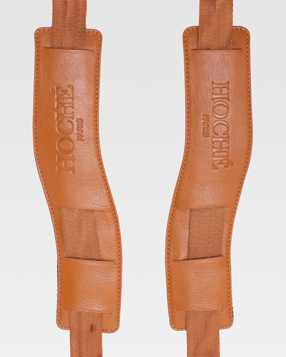 Close-up of UniSwitch tan genuine leather backpack for men in India, highlighting premium craftsmanship, and Hoche paris embossed logo